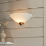 Wall light with an aged brass finish complete with a white painted glass shade. (0711WEL112439)